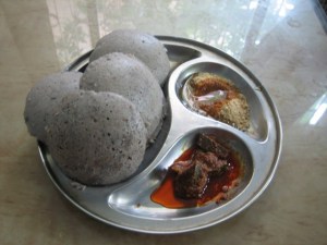 Soak 1 cup brown rice and 1.5 cups whole urad or urad dal with peel intact.  Grind and allow to rise overnight.  Steam in idli plates as usual.   Shown with avakayi and idli poDi. 