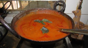 Soup simmers in iron wok